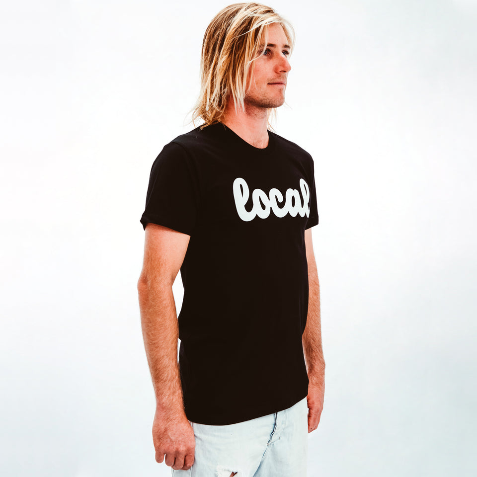 Model Shot wearing Mens Black 100% cotton T-shirt with Local logo in White